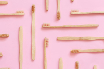 Eco friendly bamboo toothbrushes on pink background