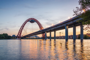 Sunset view of Picturesque bridge with big red arch over the Moscow river, Moscow, Russian Federation.