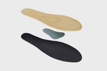Isolated orthopedic insole on a white background. Treatment and prevention of flat feet and foot diseases. Foot care, comfort for the feet. Wear comfortable shoes. Medical insoles.