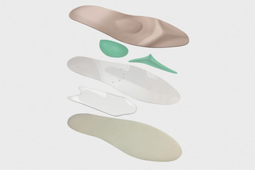 Isolated orthopedic insole on a white background. Treatment and prevention of flat feet and foot diseases. Foot care, comfort for the feet. Wear comfortable shoes. Medical insoles.