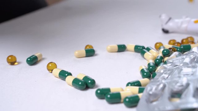 Dog's paw dressed as doctor goes over bunch of pills and looks for the right one