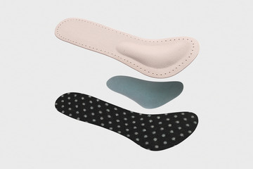 Isolated orthopedic insole on a white background. Treatment and prevention of flat feet and foot diseases. Foot care, comfort for the feet. Wear comfortable shoes. Medical insoles.
