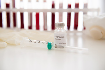 Test tubes with blood sample Covid-19 coronavirus. Vaccine and syringe injection It use for...