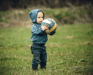 little boy with a ball on the floor