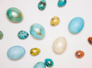 Fototapeta na wymiar Blue colored Easter eggs with gold elements on a white background. Minimalism. Happy Easter!