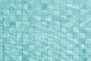 Top view water swimming pool with bottom mosaic wall background and clear water ripple