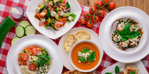 Pumpkin soup with feta cheese and vegetables, dietary vegan salad. Mix of Italian Vegetarian dishes.