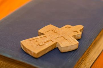 Closeup of wooden Christian cross on bible