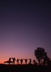 silhouettes of people on a sunset