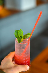 Red colorful refreshing cocktail with ice and lime. Fruit tropical mix drink.