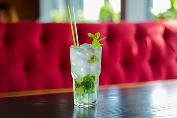 Green Mohito colorful refreshing cocktail with ice and lime. Fruit tropical mix drink.