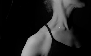 Sexy fit females shoulder neck and chest in the black background studio