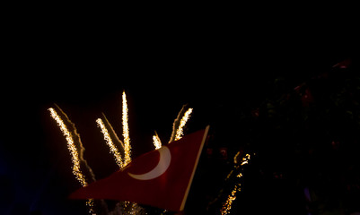 Colorful fireworks on the black sky background with Turkish flag.
