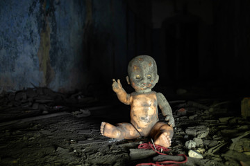 scary doll in the ruins of an abandoned bunker