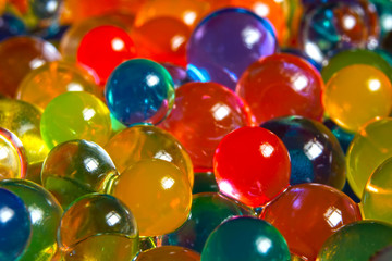 background of multi-colored, blurry, wet hydrogel balls