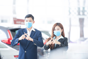 Asian businessmen wear medical masks, raise hands for stop signs to not enter quarantine areas that...