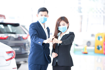 Asian businessmen wear medical masks, raise hands for stop signs to not enter quarantine areas that...