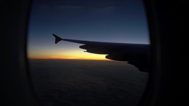 Sunset through plane window handheld