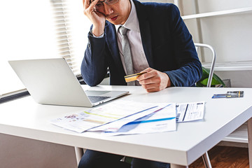Asian strain man in suit suspect was made on credit cards he held.He has problem with his expense,...