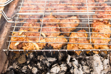 Cooking a barbecue on the grill. Shish kebab with pieces of pork neck and ribs marinated with...