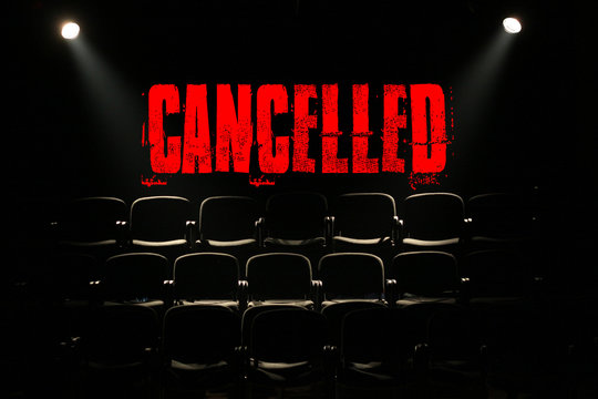 Empty seats on a back background with the text "cancelled".