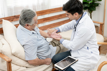 Asian elderly man are sick doctor to check their symptoms at home. Health care , life style,...