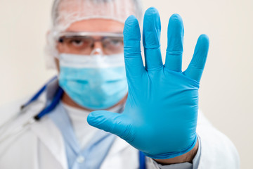 caucasian doctor showing hand stop sign