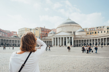 Young woman tourist in the front of Piazza del Plebiscito