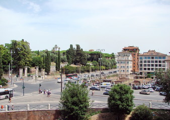 View from the window of the Colosseum on numerous park areas of the Italian capital on a background of cloudy summer sky.
