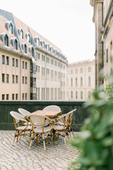  a table outside the restaurant overlooking an old European street