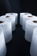 Lines of toilet paper on dark background with perspective