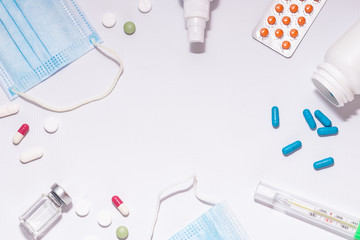 Pandemic prevention banner with medical masks, antiseptic spray, vitamins, vaccines and thermometer on white background with copy space for your design. 