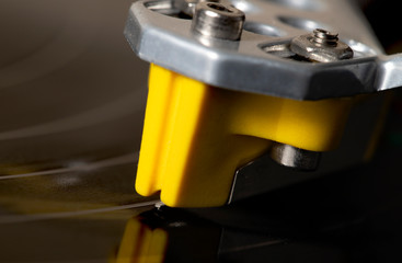 Turntable arm needle on the record closeup view