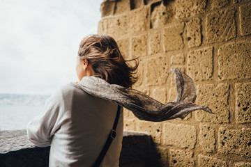 Young woman tourist in the arch of Castel dell'Ovo