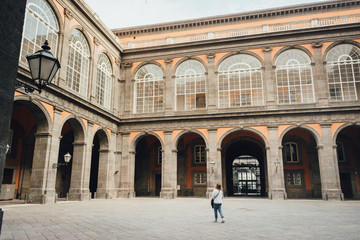 Obraz premium Young woman tourist exploring Royal Palace of Naples