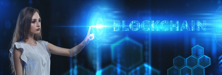 Business, Technology, Internet and network concept. Young businessman working on a virtual screen of the future and sees the inscription: Blockchain