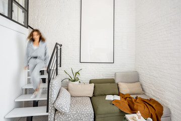 Interior view of the bright modern living room with a blurred in motion human figure
