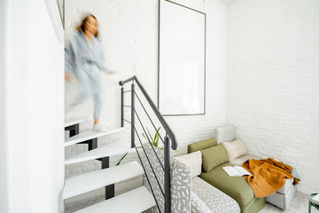 Interior view of the bright modern living room with a blurred in motion human figure