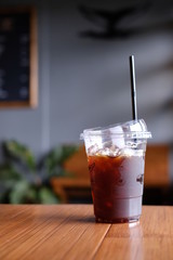 Ice Coffee Americano Plastic  On Wood Background  Cafe 