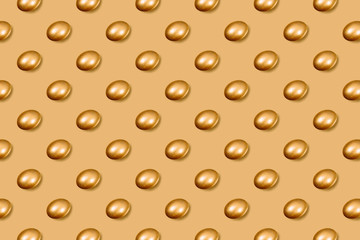 Pattern made of golden eggs on golden background.