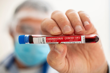 Fototapeta premium Doctor holding test tube blood sample