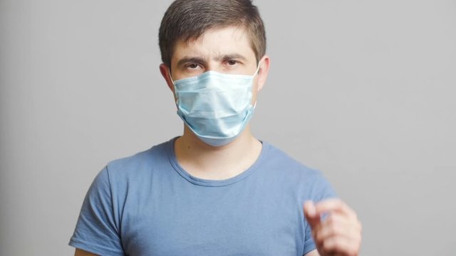 tired doctor remove a protective surgical mask at the end of the operation, concept of failure, health and and powerlessness of medicine