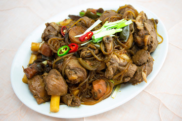Korean chicken stew with soy sauce, glass noodle, rice cake and vegetables