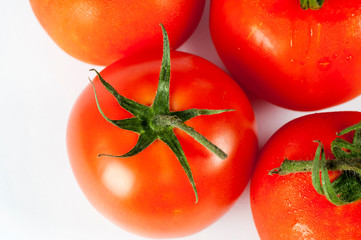 Close up of tomatoes on white background. Wallpaper tomato macro. Top view of tomatoes.