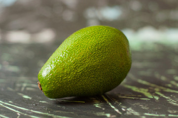 Avocado on a dark gray background, top view copy space
