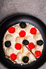 Cake with mascarpone cream on a gray noble background. Top view. Close-up