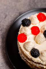 Cake with mascarpone cream on a gray noble background. Top view. Macro.