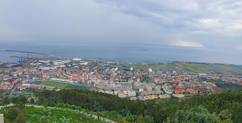 Fototapeta na wymiar Top view from the hill of city and sea coast