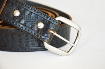 Leather belt. Brown belt on a light background.
