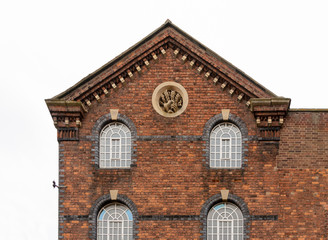 Fototapeta na wymiar Decorative red brick building with ornate detail Tewkesbury Gloucestershire England UK